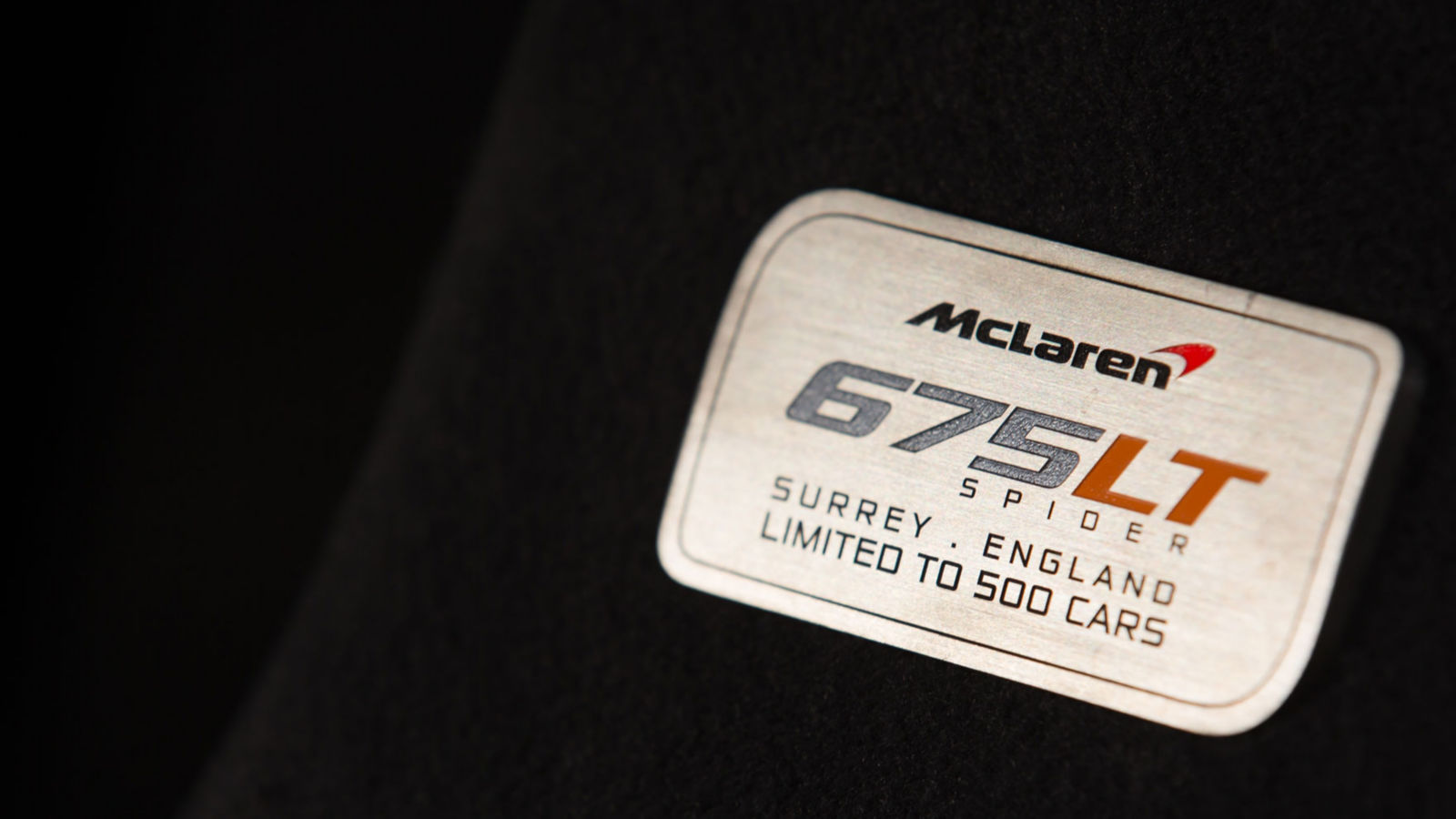 McLaren 675LT Spider nameplate, highlighting its limited production of 500 units and exclusive craftsmanship from Surrey, England