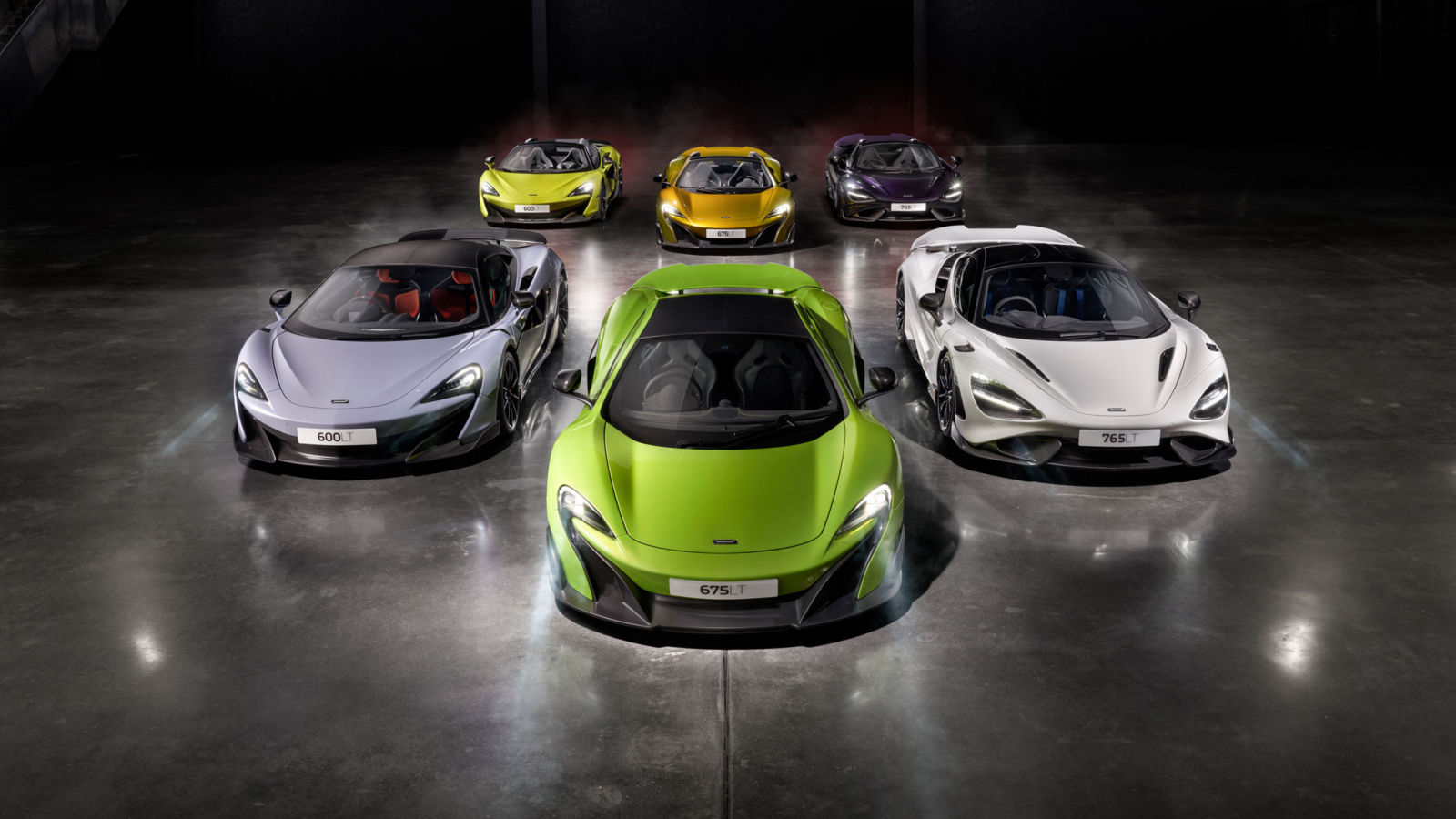 McLaren LT supercar lineup arranged in a V formation, featuring 600LT, 675LT, and 765LT models in bold colors, showcasing aerodynamics.