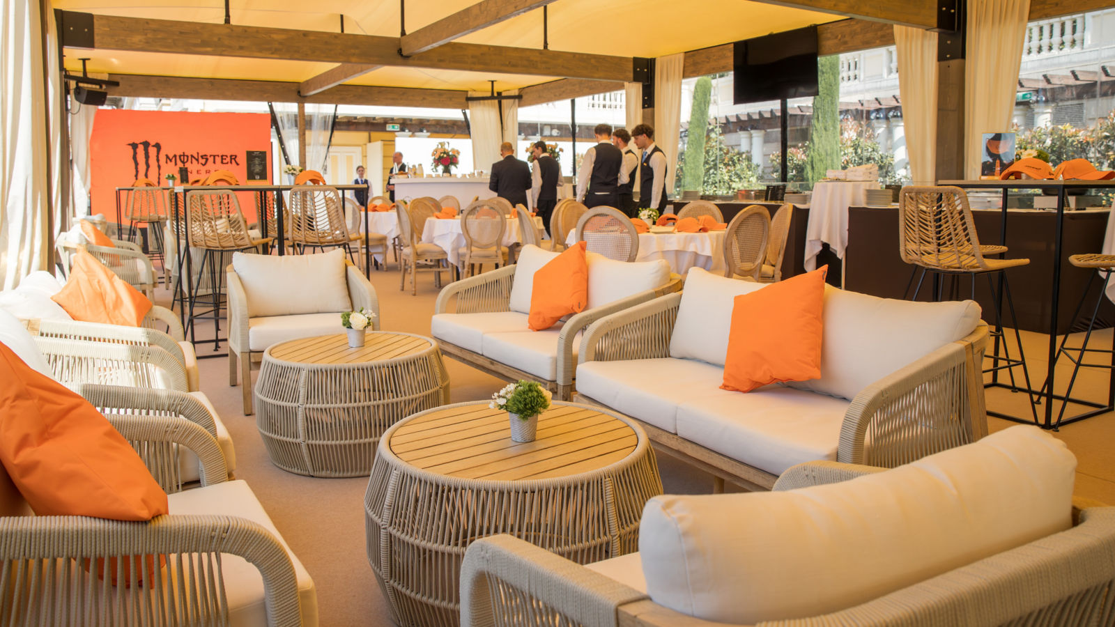 Two McLaren guests wearing McLaren merchandise, overlooking the Monaco harbour.