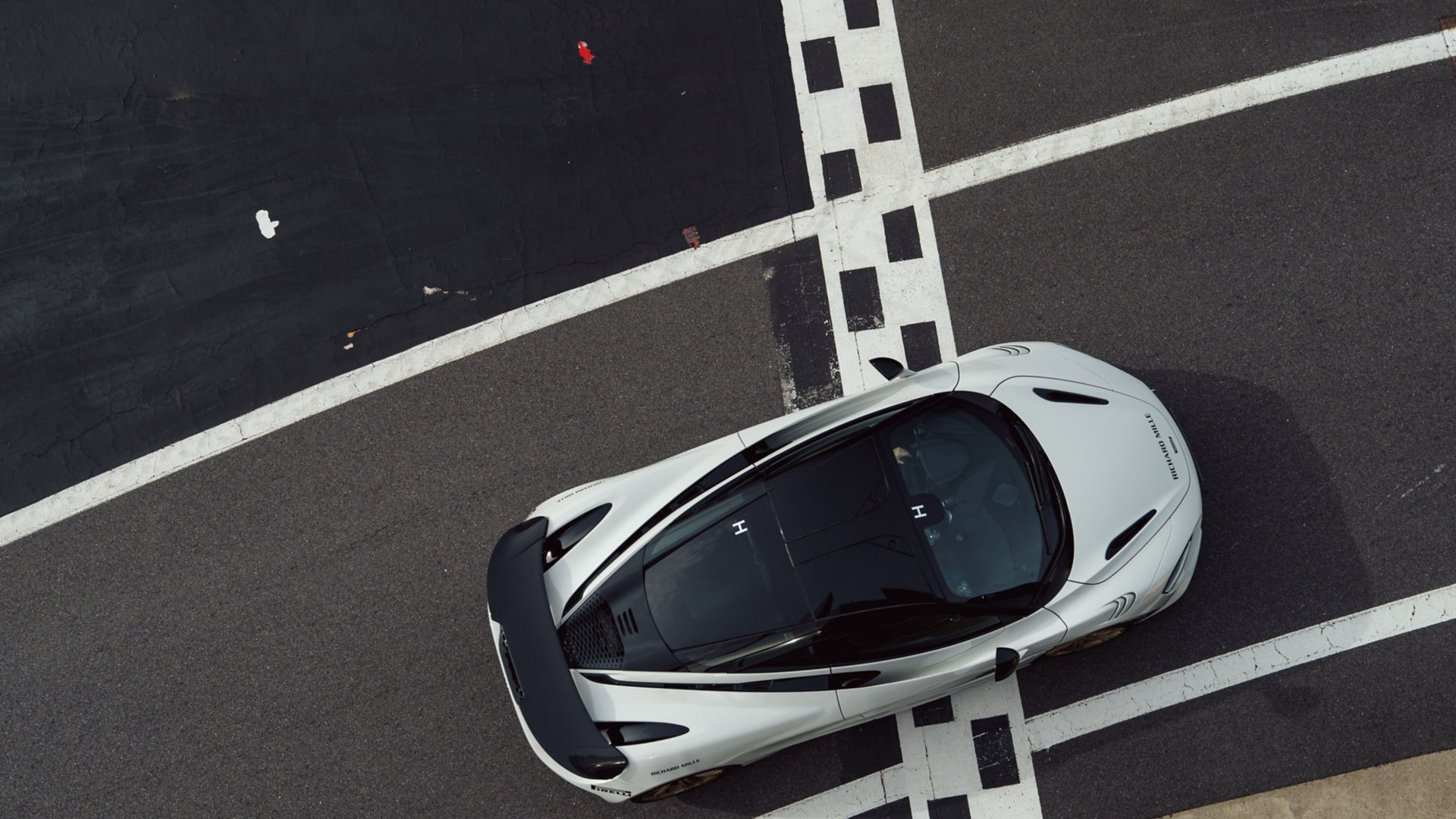 The McLaren Solus GT driving at speed along the Silverstone Track.