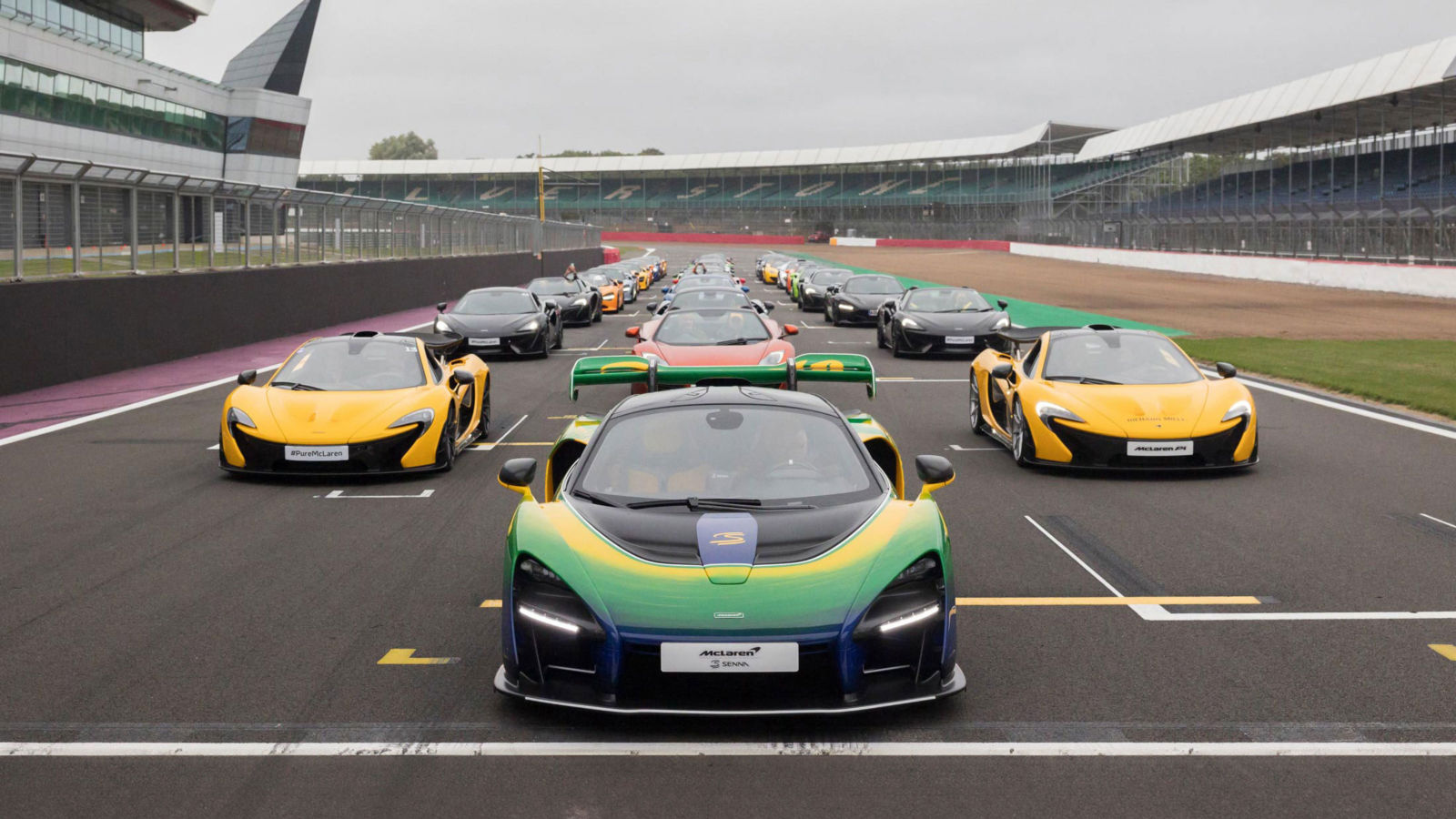 McLaren Supercars aligned on the Silverstone track.