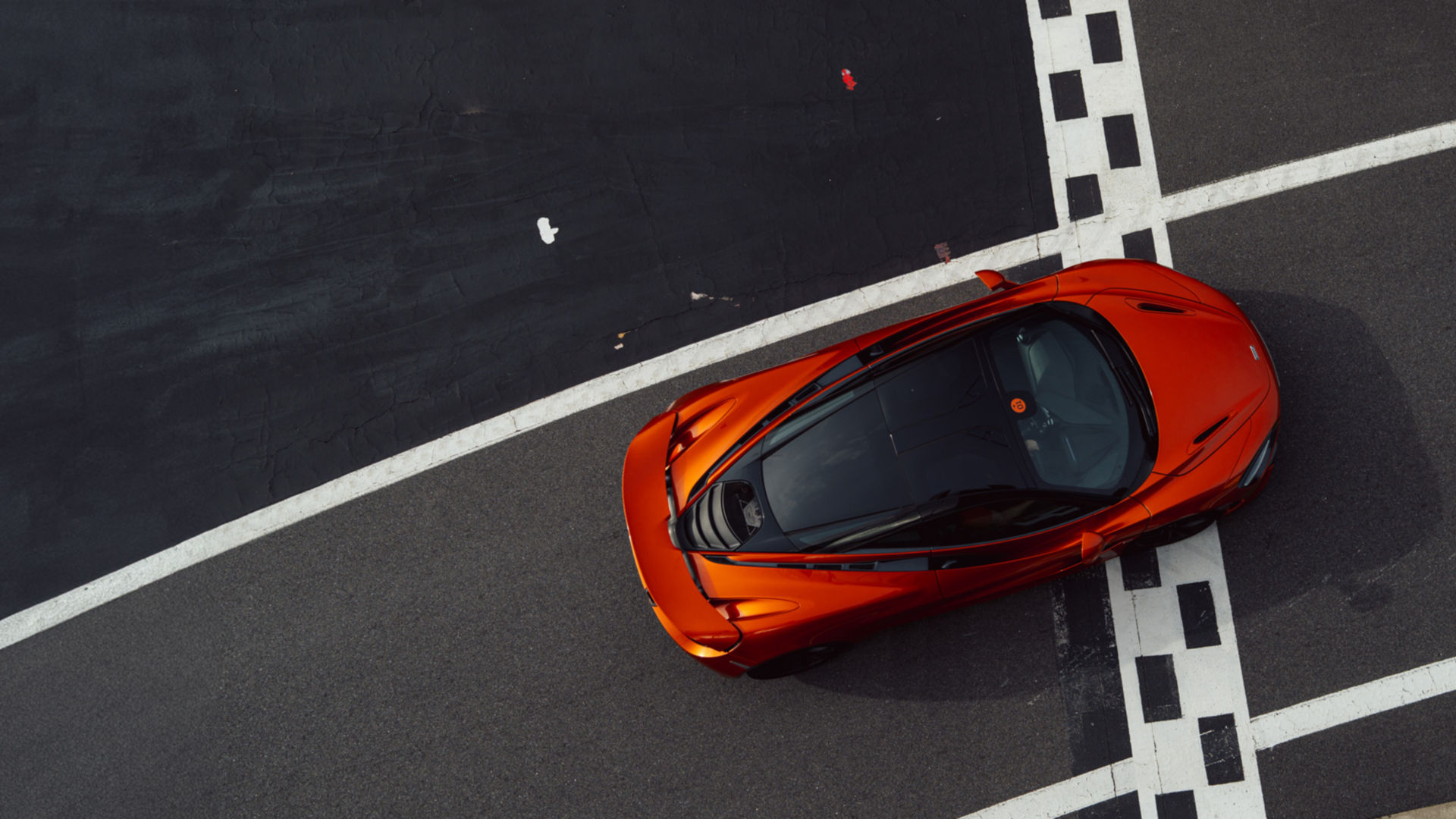 The McLaren Solus GT driving at speed along the Silverstone Track.