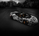 Full view of the McLaren 750S Spider 'Project Viva' by MSO, featuring a hand-painted monochrome livery inspired by Las Vegas and set against a dark city skyline, showcasing a one-of-one bespoke supercar.