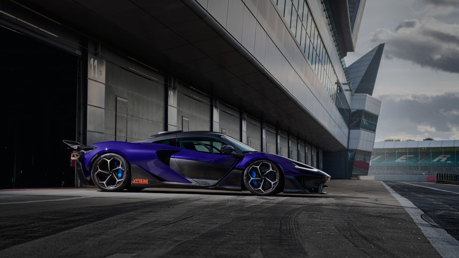 A shot of the side of a McLaren W1 prototpye parked within the pit lane of the Silverstone track.