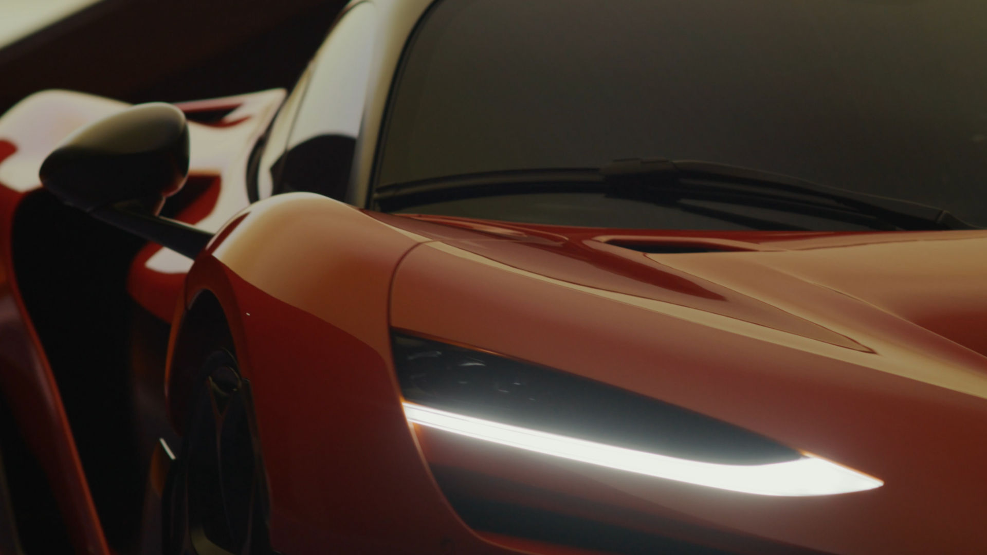 Video-poster-close-up of a papaya McLaren W1 supercar with LED headlights, highlighting luxury design and aerodynamic styling